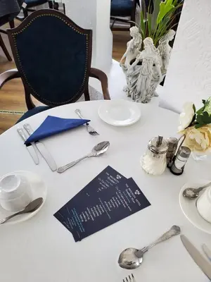 a white table with silver utensils and a plate at Brooklyn Hotel in Blackpool