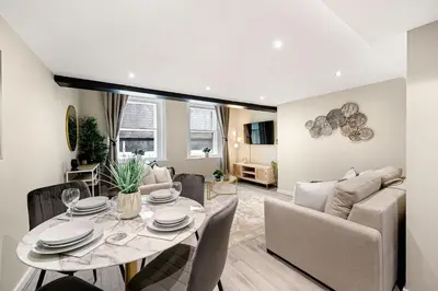 a living room with a table and a couch at Host & Stay - Halifax House Living in Liverpool