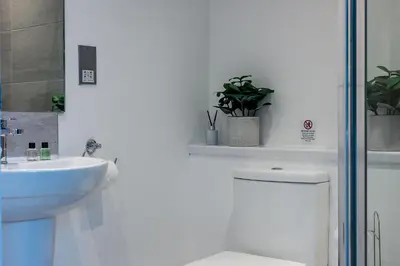 a white bathroom with a toilet and a sink at Host & Stay - Halifax House Living in Liverpool