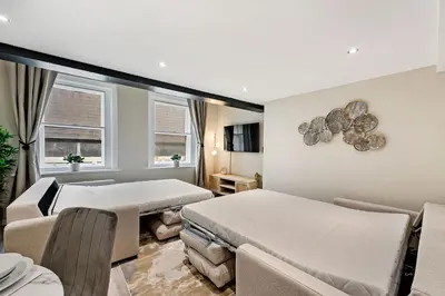 a bedroom with two beds and a couch at Host & Stay - Halifax House Living in Liverpool