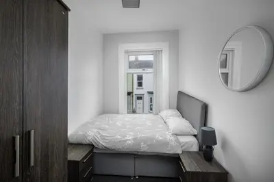 a small bedroom with a bed and a mirror at Lovely Home in Blackpool For You in Blackpool