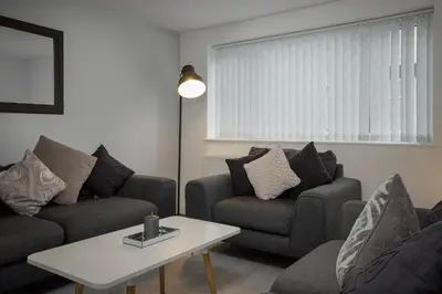 a living room with two couches and a table at Lovely Home in Blackpool For You in Blackpool