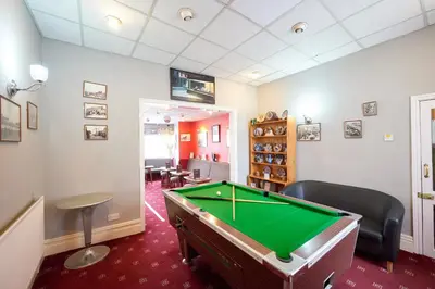 a billiard room with a pool table in it at The Wilton International in Blackpool