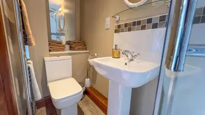 a bathroom with a toilet and a sink at The Hayloft, Broughton Beck, near Ulverston budget friendly accommodation close to a beach and Windermere in Spark Bridge