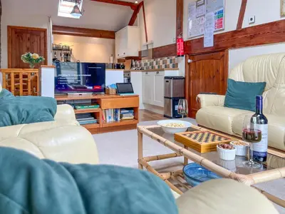 a living room with two white couches and a table at The Hayloft, Broughton Beck, near Ulverston budget friendly accommodation close to a beach and Windermere in Spark Bridge