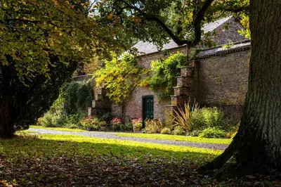 a brick house with a tree in front of it at Lytham Hall Gate House in Lytham St Annes