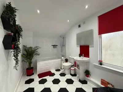a bathroom with a black and white checkered floor at Anfield Abode - ENTIRE LFC THEMED HOUSE - Sleeps 6 in Liverpool