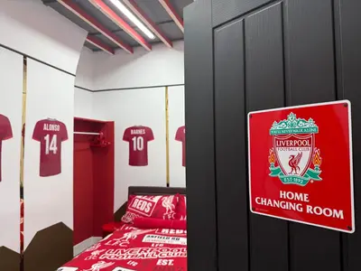 a bedroom with a home changing room withttenham jerseys at Anfield Abode - ENTIRE LFC THEMED HOUSE - Sleeps 6 in Liverpool