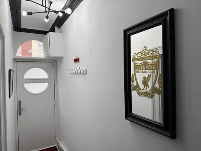 a mirror on a wall next to a door at Anfield Abode - ENTIRE LFC THEMED HOUSE - Sleeps 6 in Liverpool