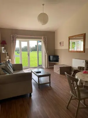 a living room with a couch and a table at Another Place in Formby
