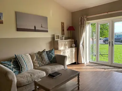 a living room with a couch and a table at Another Place in Formby