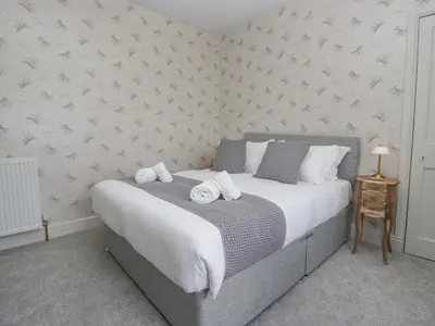 a bedroom with a bed with towels on it at Holmere Bank in Carnforth