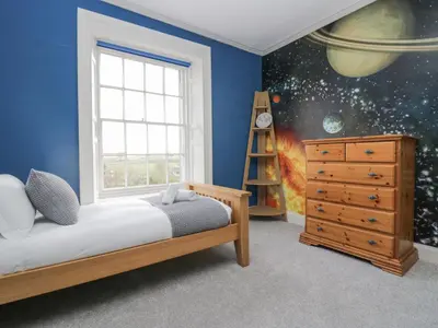 a bedroom with a bed and a window at Holmere Bank in Carnforth