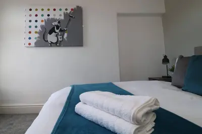 a bedroom with a bed with towels on it at Lancaster 2 Bedroom Characterful House - with Wifi in Lancaster