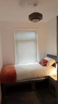 a bed sitting in a room with a window at Ribbleton Rendezvous in Preston in Preston