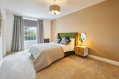 a bedroom with a large bed and a window at Host & Stay - South View in High Newton