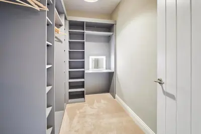 a walk in closet with white walls and shelves at Host & Stay - South View in High Newton