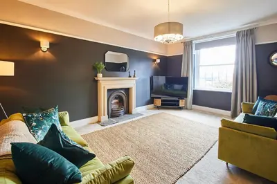 a living room with a couch and a fireplace at Host & Stay - South View in High Newton