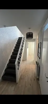 a staircase in a room with a bed and a hallway at Entire 3 bedrooom holiday home in Liverpool