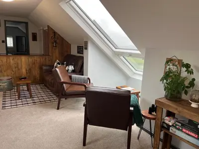 a living room with a skylight on the ceiling at Loft apartment in Accrington Stunning Lancashire views in Church