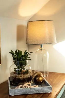 a table with a lamp and a vase and a plant at Loft apartment in Accrington Stunning Lancashire views in Church