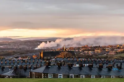 a view of a city with smoke in the distance at Loft apartment in Accrington Stunning Lancashire views in Church