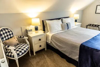 a bedroom with a bed and a chair at Loft apartment in Accrington Stunning Lancashire views in Church