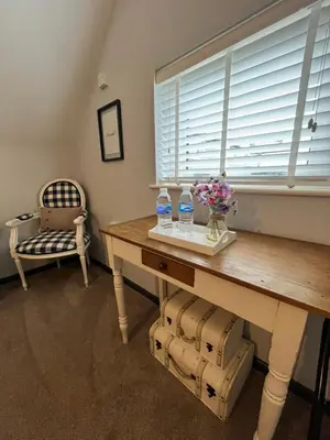 a table with two bottles of water and flowers on it at Loft apartment in Accrington Stunning Lancashire views in Church