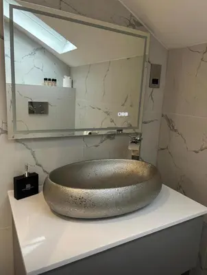 a bathroom with a large bronze sink on a counter at Philharmonic Hotel in Liverpool