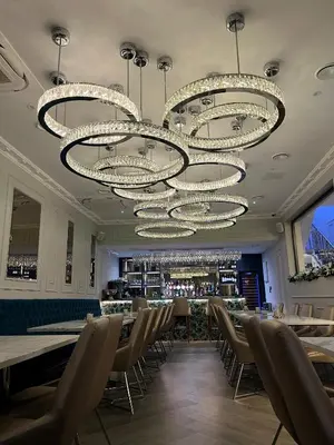 a dining room with tables and chairs and chandeliers at Philharmonic Hotel in Liverpool