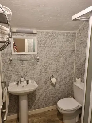 a small bathroom with a sink and a toilet at Lexham Apartments in Blackpool