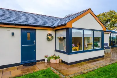 a home with a blue door and windows at The Knoll Lodge- Beautiful Luxurious One Double Bedroom Property in Farington