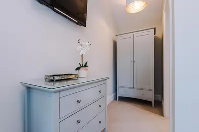 a bedroom with a blue dresser and a closet at The Knoll Lodge- Beautiful Luxurious One Double Bedroom Property in Farington