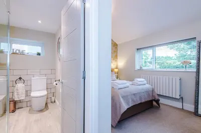 a small bedroom with a bed and a bathroom at The Knoll Lodge- Beautiful Luxurious One Double Bedroom Property in Farington
