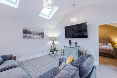 a living room with two couches and a flat screen tv at The Knoll Lodge- Beautiful Luxurious One Double Bedroom Property in Farington