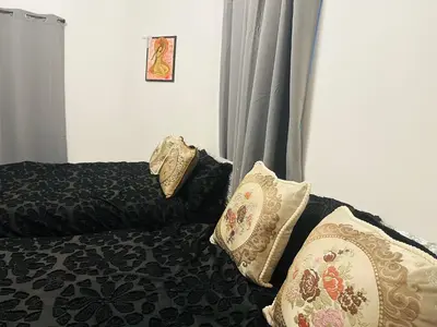 a bedroom with a bed with pillows on it at Samco flat in Ashton in Makerfield