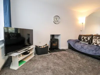 a living room with a flat screen tv and a couch at 3 Thrimby Court in Morecambe