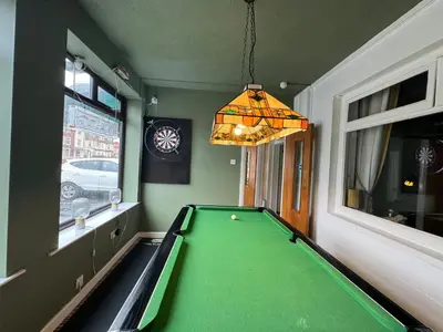 a billiard room with a green pool table at The Scala Hotel in Blackpool