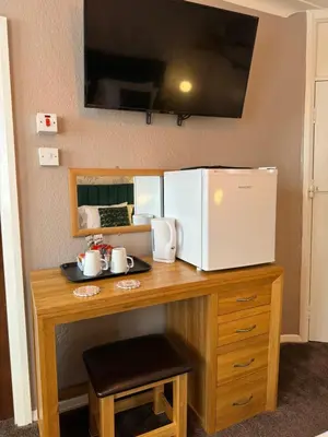 a kitchen counter with a microwave and a refrigerator at The Scala Hotel in Blackpool