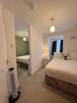 a bedroom with two beds and a mirror at The Scala Hotel in Blackpool