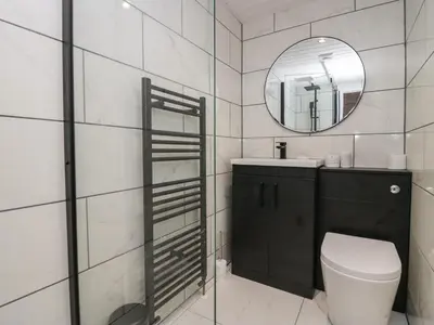 a bathroom with a toilet and a mirror at Eden on the Crescent in Morecambe