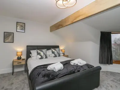a bedroom with a bed with towels on it at Eden on the Crescent in Morecambe