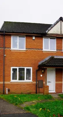 a red brick house with white windows and a driveway at The Oasis - For Contractors and Individuals in Wigan