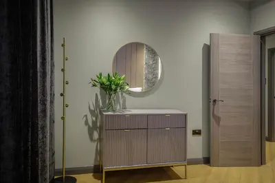 a dressing room with a mirror and a dresser at Signature Apartments in Blackpool