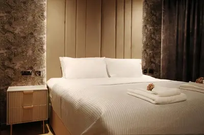 a bedroom with a bed with towels on it at Signature Apartments in Blackpool