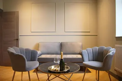 a living room with a couch and a table and chairs at Signature Apartments in Blackpool