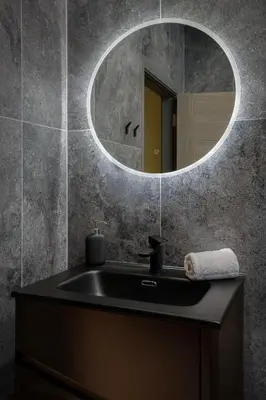 a bathroom with a black sink and a mirror at Signature Apartments in Blackpool