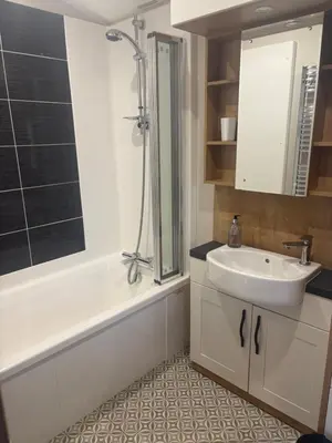 a bathroom with a sink and a bath tub and a sink at 8 lakeview in Clitheroe