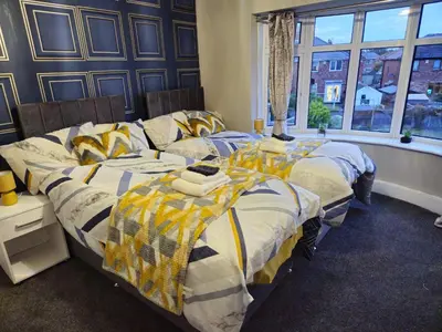 a bedroom with two beds and a window at Number 1 Preston Stays in Preston