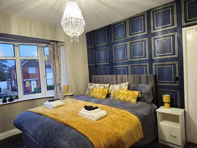 a bedroom with a large bed with towels on it at Number 1 Preston Stays in Preston